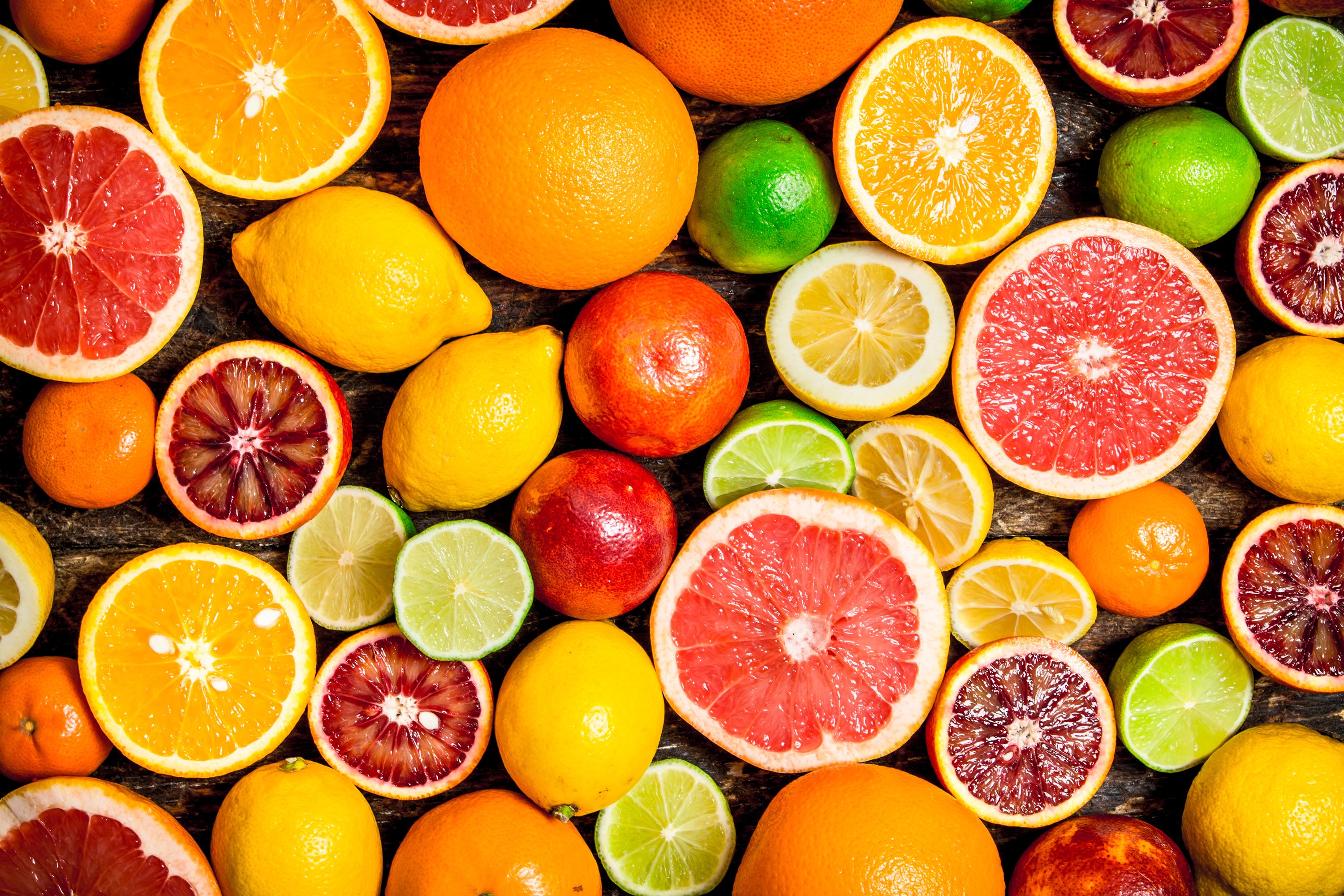 Citrus background. Fresh citrus fruits – Lemons, oranges, limes, grapefruits.